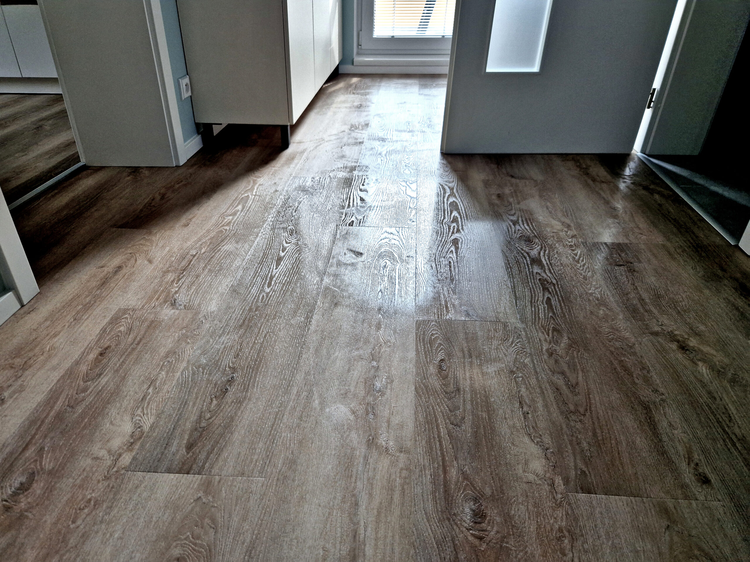 Freshly cleaned Luxury Vinyl Plank (LVP) flooring with a polished, streak-free finish.