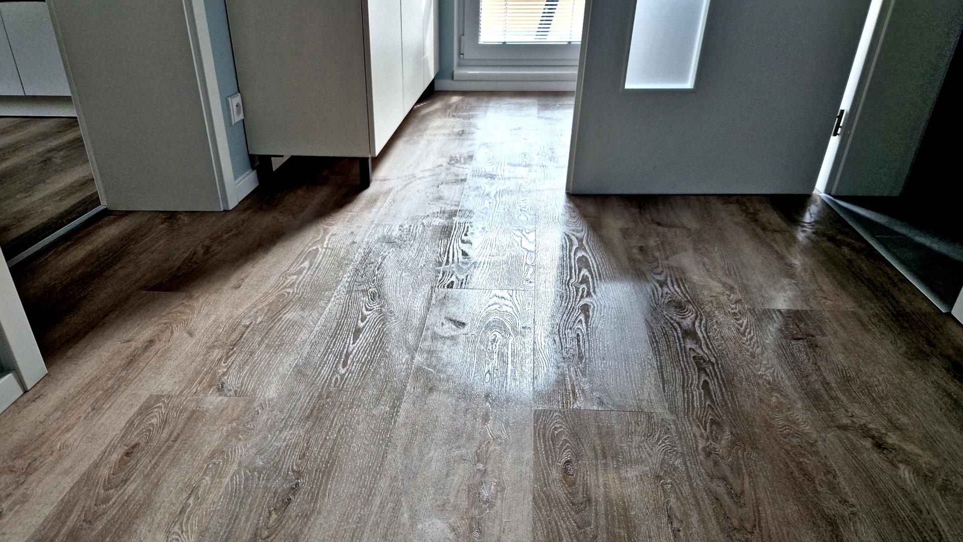 luxury-vinyl-plank-cleaning-button Freshly cleaned Luxury Vinyl Plank (LVP) flooring with a polished, streak-free finish.